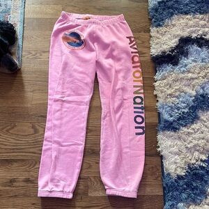 Pink, medium aviator nation sweats with the logo down the pant.